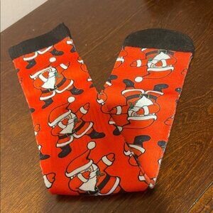 Festive Santa Socks featuring a pattern of Santa Claus dabbing